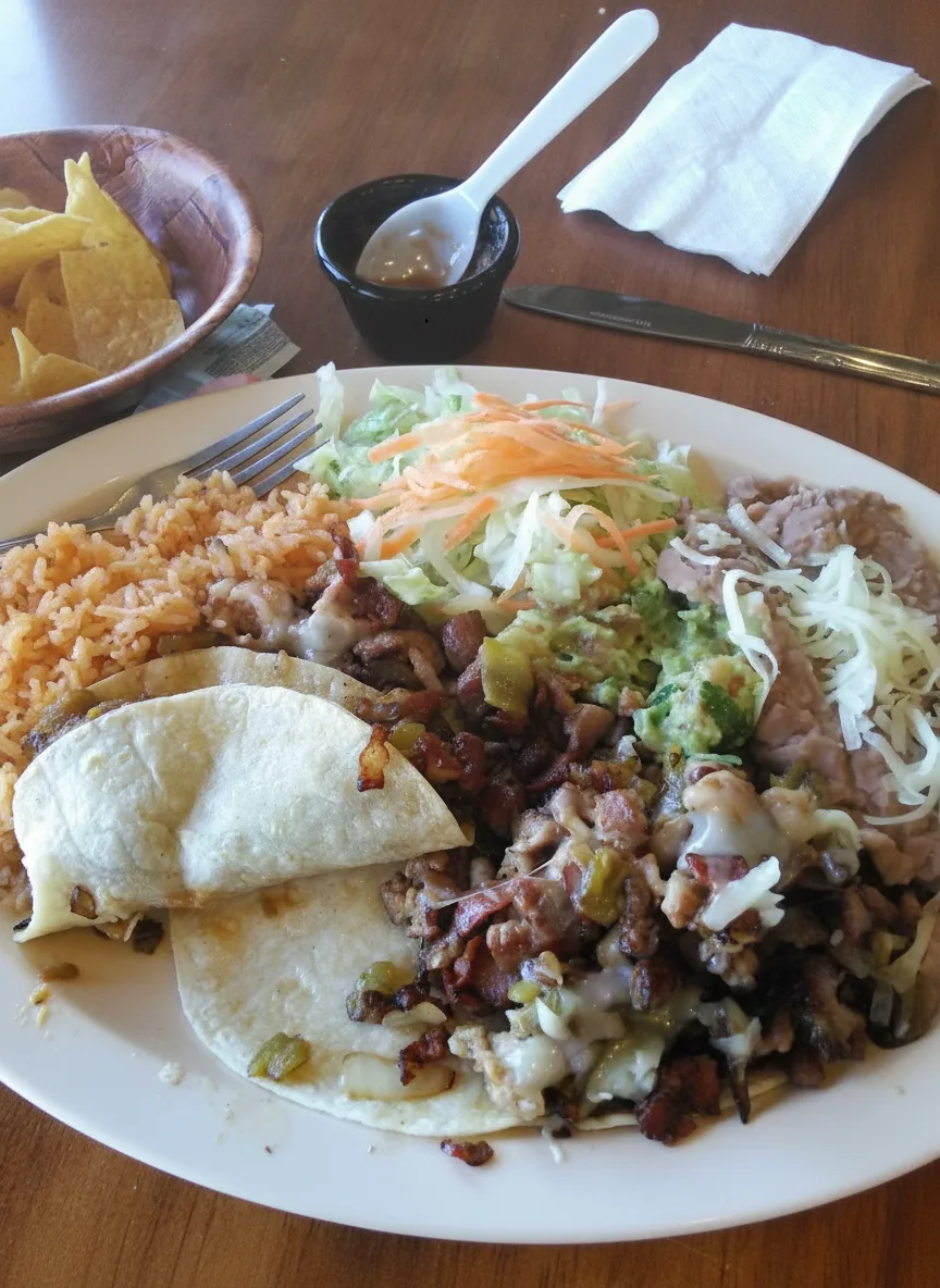 Tacos with grilled meat and peppers, rice and beans