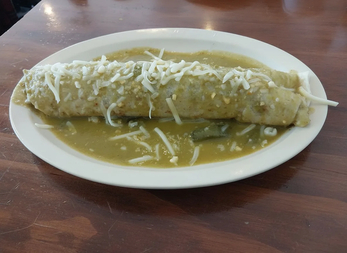 Barbacoa burrito smothered in green sauce