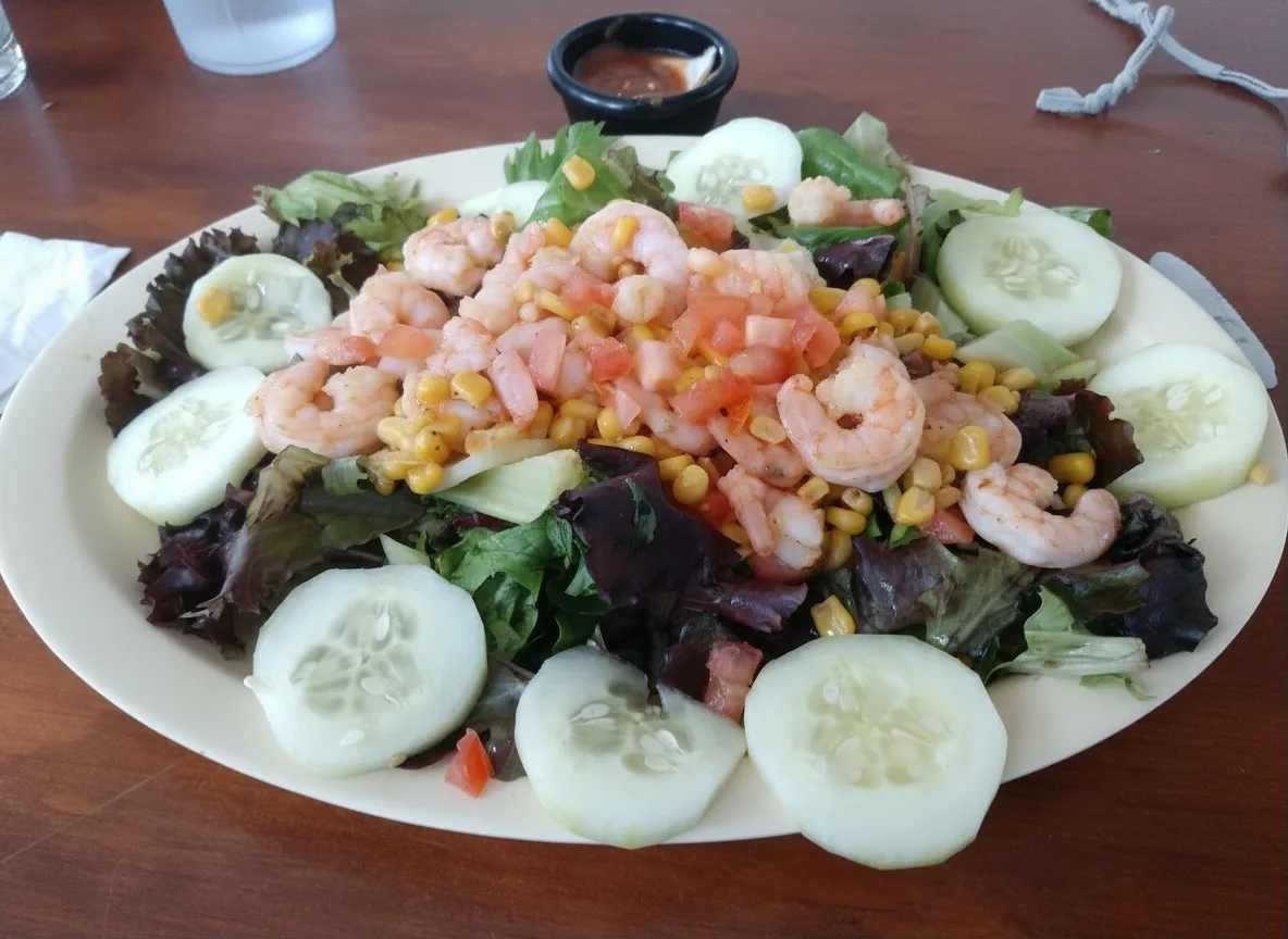 Shrimp salad with cucumber, tomato and corn