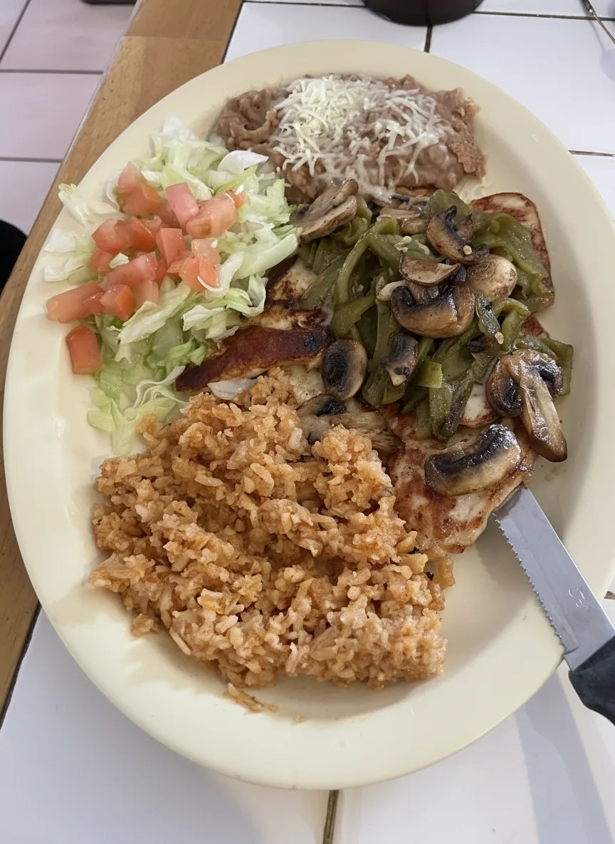 Chicken breast with mushrooms and green chile, rice, beans and salad